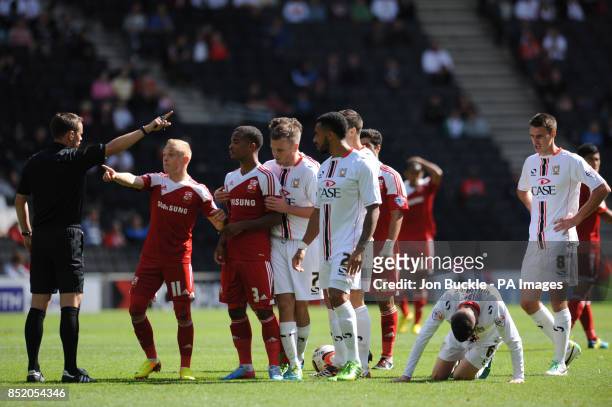 Referee Stuart Attwell sends off Nathan Bryne of Swindon Town after a challenge on Milton Keynes Dons' Shaun Willaims during the Sky Bet Football...