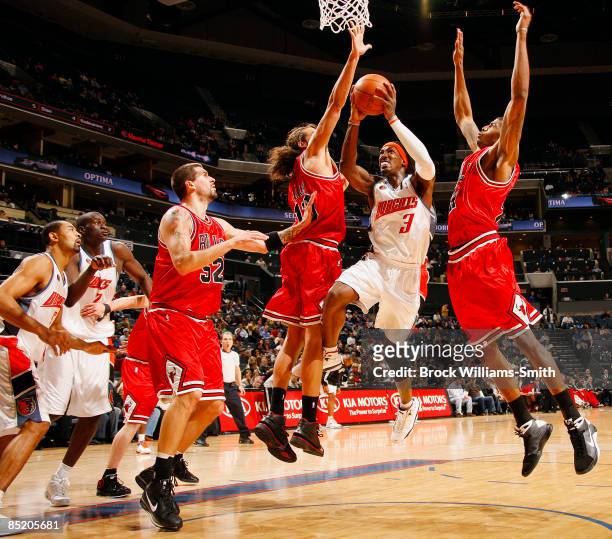 Gerald Wallace of the Charlotte Bobcats drives to the basket against Joakim Noah of the Chicago Bulls on March 3, 2009 at the Time Warner Cable Arena...
