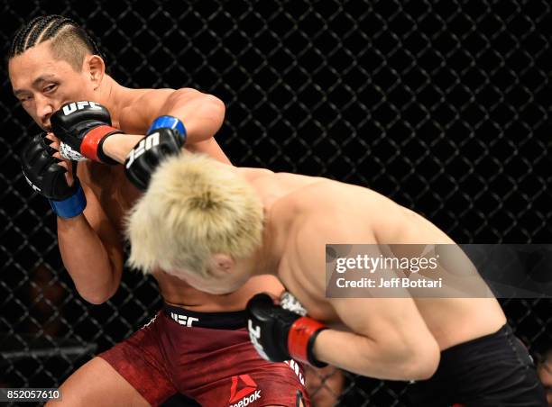 Takanori Gomi of Japan punches Dong Hyun Kim of South Korea in their lightweight bout during the UFC Fight Night event inside the Saitama Super Arena...