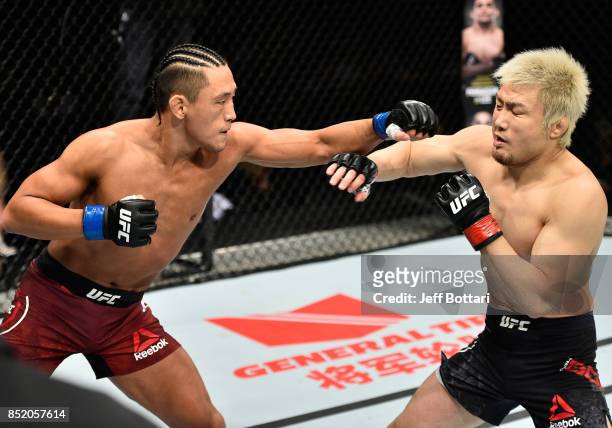 Dong Hyun Kim of South Korea punches Takanori Gomi of Japan in their lightweight bout during the UFC Fight Night event inside the Saitama Super Arena...