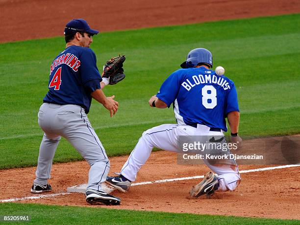 Willie Bloomquist of the Kansas City Royals gets hit on the shoulder by the baseball as third baseman Tony Graffanino of the Cleveland Indians...