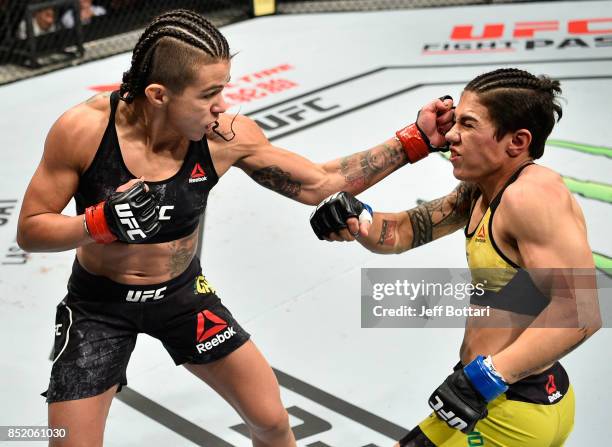 Claudia Gadelha of Brazil punches Jessica Andrade of Brazil in their women's strawweight bout during the UFC Fight Night event inside the Saitama...