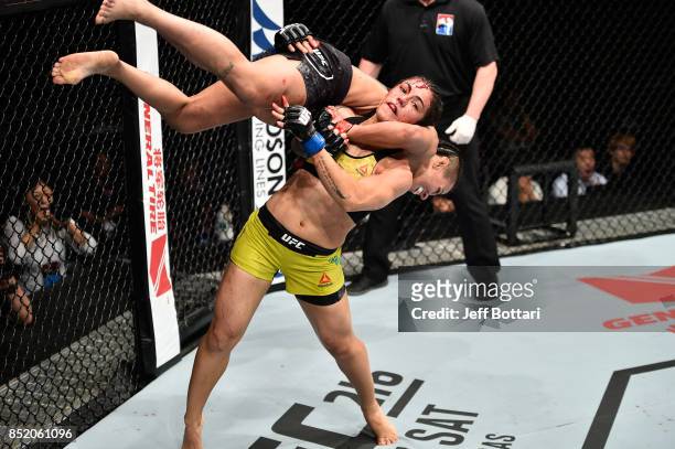 Jessica Andrade of Brazil takes down Claudia Gadelha of Brazil in their women's strawweight bout during the UFC Fight Night event inside the Saitama...