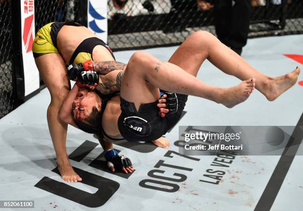 Jessica Andrade of Brazil takes down Claudia Gadelha of Brazil in their women's strawweight bout during the UFC Fight Night event inside the Saitama...