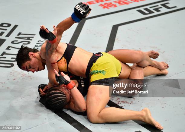 Jessica Andrade of Brazil punches Claudia Gadelha of Brazil in their women's strawweight bout during the UFC Fight Night event inside the Saitama...