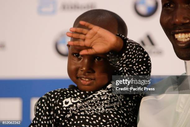 Wilson Kipsang poses with his young daughter Joy for the cameras. The three leading runners competing in the 44th BMW Berlin Marathon, Eliud Kipchoge...