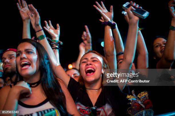 Fans of American singer Jon Bon Jovi react as he performs during the Rock In Rio Festival at the Olympic Park, Rio de Janeiro, Brazil, on September...