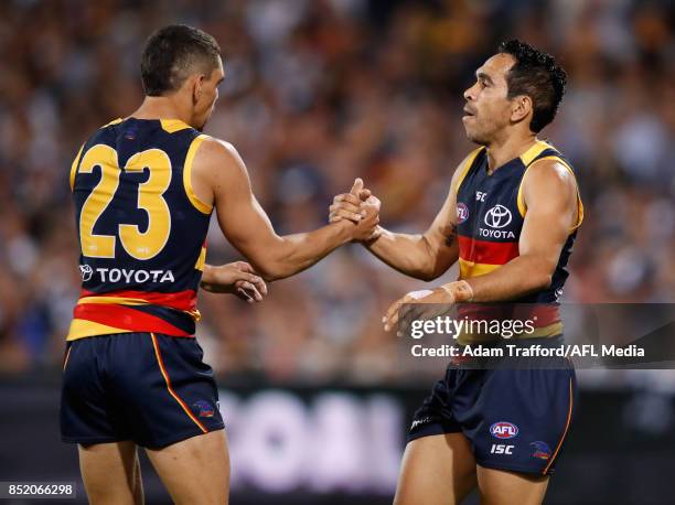 Eddie Betts of the Crows congratulates Charlie Cameron of the Crows on a goal during the 2017 AFL First Preliminary Final match between the Adelaide...