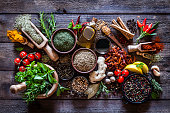 Spices and herbs on rustic wood kitchen table