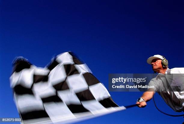 motor racing, official waving chequered flag (blurred motion) - race official stock pictures, royalty-free photos & images