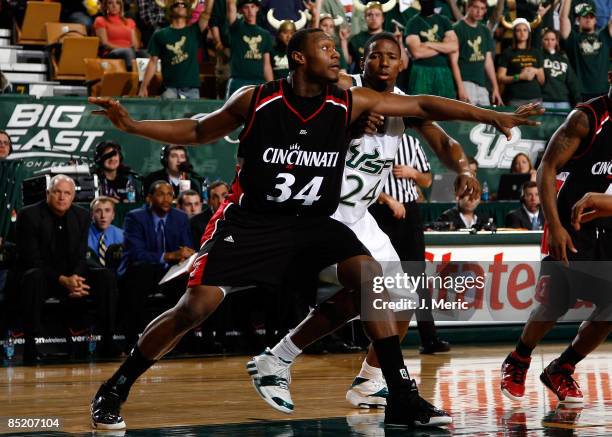 Yancy Gates of the Cincinnati Bearcats boxes out Augustus Gilchrist of the South Florida Bulls during the game at the SunDome on March 3, 2009 in...