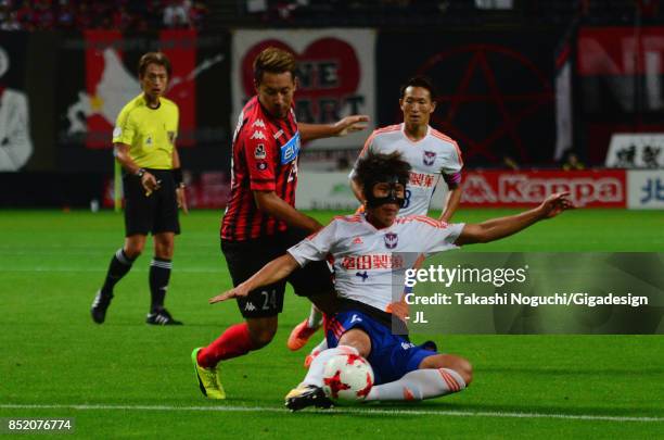 Song Ju Hun of Albirex Niigata and Akito Fukumori of Consadole Sapporo compete for the ball during the J.League J1 match between Consadole Sapporo...