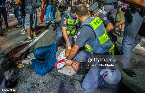 Police arrest a protester against the decision of a Brazilian judge who approved gay conversion therapy in Sao Paulo, Brazil on September 22, 2017....