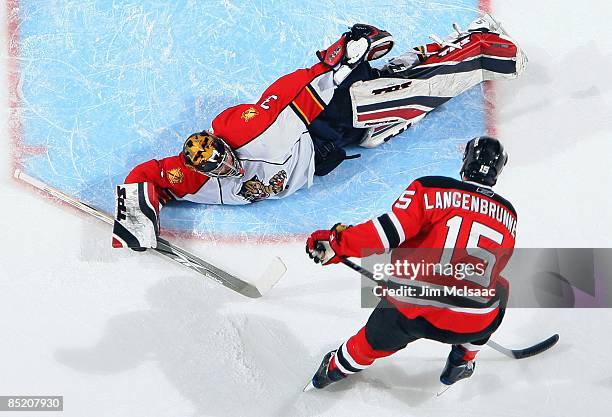 Craig Anderson of the Florida Panthers makes a save against Jamie Langenbrunner of the New Jersey Devils at the Prudential Center on February 28,...