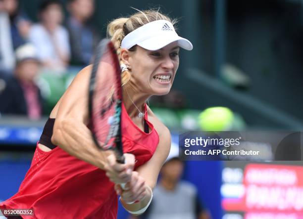 Angelique Kerber of Germany returns a shot to Anastasia Pavlyuchenkova of Russia during their women's singles semi-final match at the Pan Pacific...