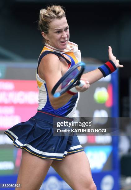 Anastasia Pavlyuchenkova of Russia returns a shot to Angelique Kerber of Germany during their women's singles semi-final match at the Pan Pacific...