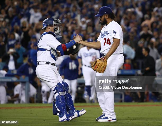 Catcher Yasmani Grandal and closing pitcher Kenley Jansen of the Los Angeles Dodgers shake hands after their 4-2 win in an MLB game against the San...