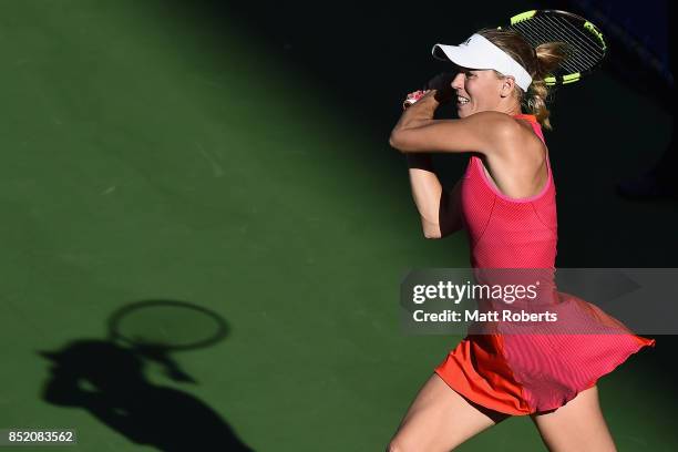 Caroline Wozniacki of Denmark plays a backhand in her semi final match against Garbine Muguruza of Spain during day six of the Toray Pan Pacific Open...