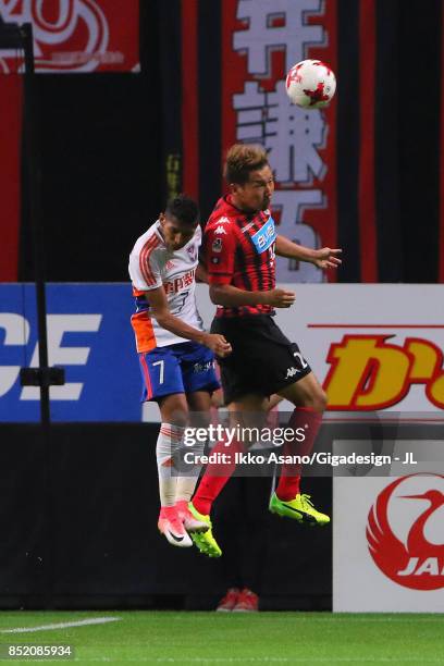 Akito Fukumori of Consadole Sapporo and Rony of Albirex Niigata compete for the ball during the J.League J1 match between Consadole Sapporo and...