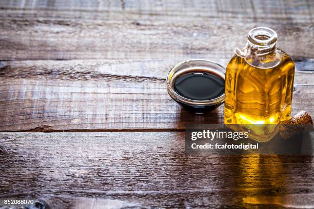 oil and vinegar on rustic wooden table - vinaigrette stock pictures, royalty-free photos & images