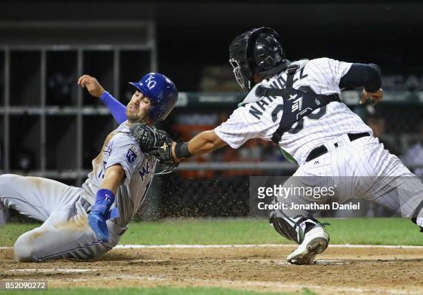 Omar Narvaez of the Chicago White Sox tags out Whit Merrifield of the Kansas City Royals in the 9th inning to start a double play to end the game at...