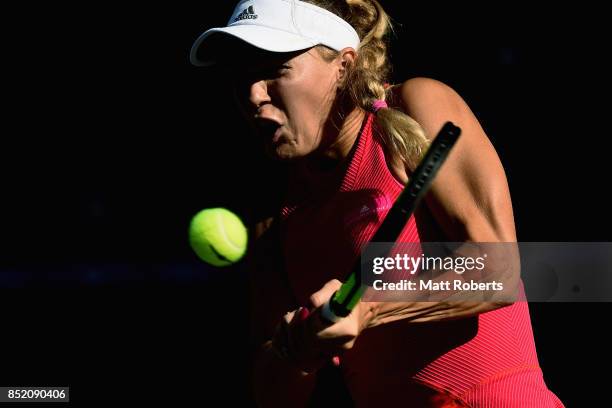 Caroline Wozniacki of Denmark plays a backhand in her semi final match against Garbine Muguruza of Spain during day six of the Toray Pan Pacific Open...