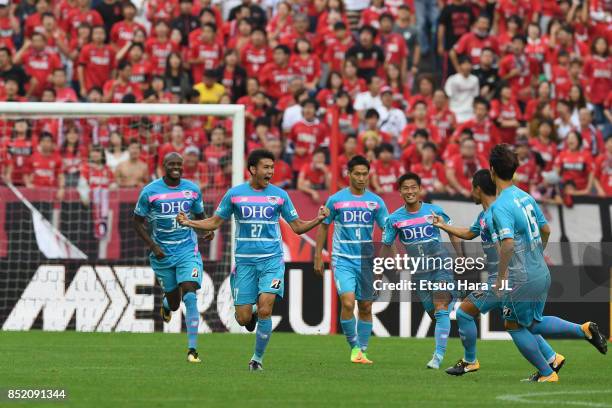 Kyosuke Tagawa of Sagan Tosu celebrates scoring his side's first goal with his team mates during the J.League J1 match between Urawa Red Diamonds and...