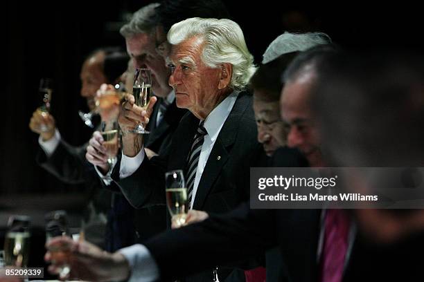 Former Australian Prime Minister Bob Hawke raises a champagne glass during a toast at a State dinner in honour of The President of the Republic of...