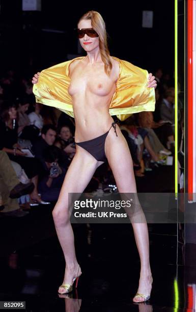 Model bears it all on the runway wearing only the barest of essentials designed by Anthony Symonds September 25, 2000 during London Fashion Week in...