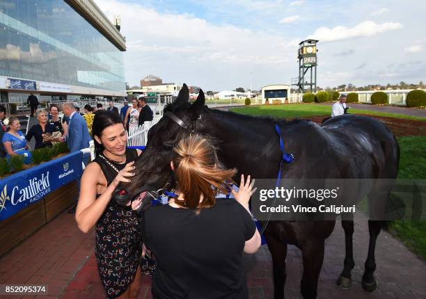 Nina O'brien gives Merriest a pat after winning Race 9 during Melbourne Racing at Caulfield Racecourse on September 23, 2017 in Melbourne, Australia.