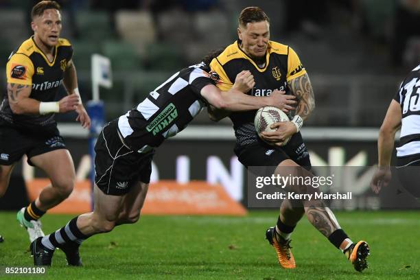 Declan O'Donnell of Taranaki is tackled by Richard Buckman of Hawke's Bay during the round six Mitre 10 Cup match between Hawke's Bay and Taranaki at...