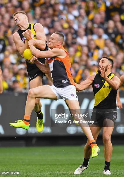 Josh Caddy of the Tigers and Tom Scully of the Giants compete for a mark during the Second AFL Preliminary Final match between the Richmond Tigers...