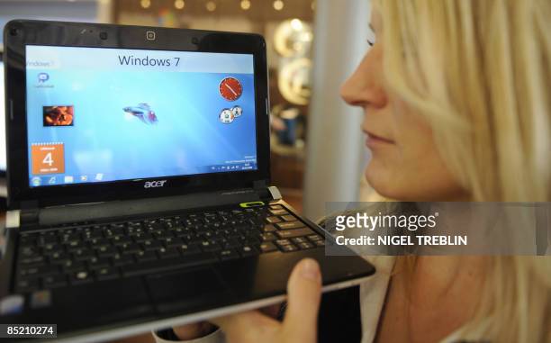 Fair hostess presents a netbook with the new Windows 7 version on March 4, 2009 at the world's biggest high-tech fair CeBIT in Hanover, central...