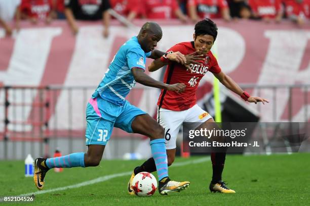 Ryota Moriwaki of Urawa Red Diamonds and Victor Ibarbo of Sagan Tosu compete for the ball during the J.League J1 match between Urawa Red Diamonds and...