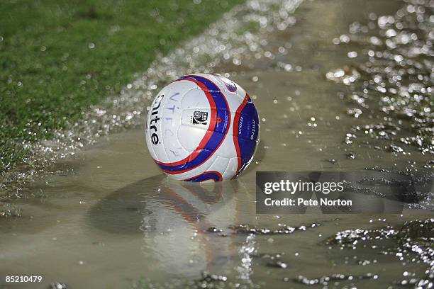 Ball sits in a puddle of water on the touchline after the abandonment of the Coca Cola League One Match between Northampton Town and Milton Keynes...