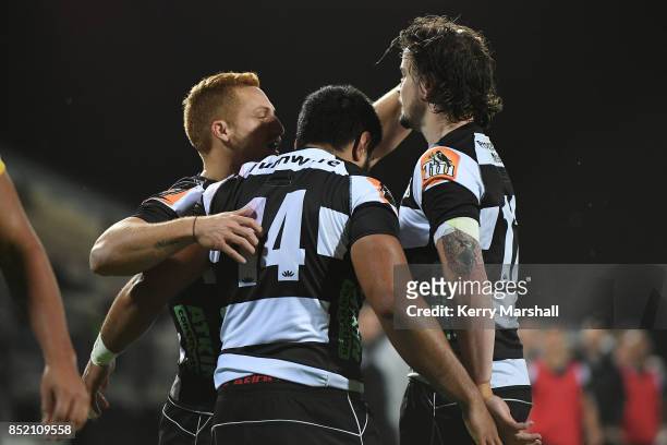 Ihaia West, Cardiff Vaega, and Richard Buckman celebrate a try during the round six Mitre 10 Cup match between Hawke's Bay and Taranaki at McLean...