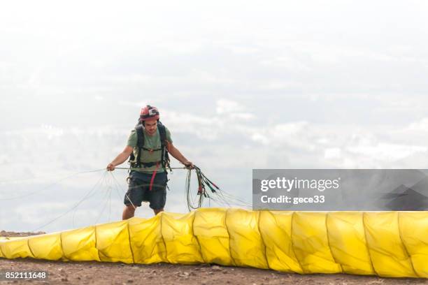 paraglider pilot preparing on pist - farm bailout stock pictures, royalty-free photos & images