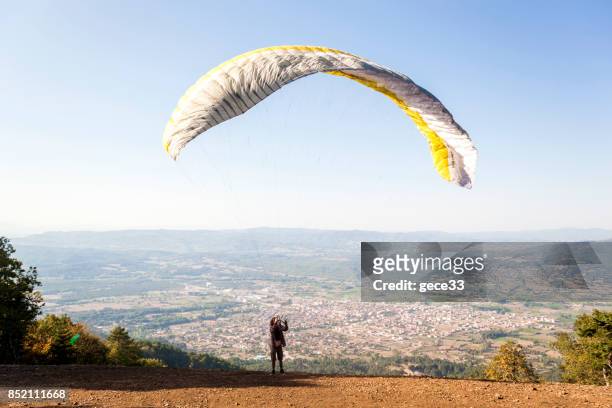 paraglider pilot training on mountain - farm bailout stock pictures, royalty-free photos & images