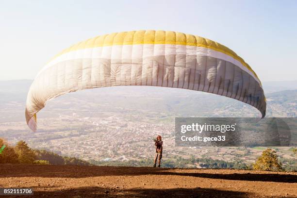 paraglider pilot training on mountain - farm bailout stock pictures, royalty-free photos & images
