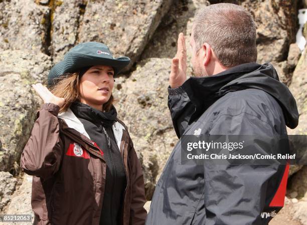 Cheryl Cole and Chris Moyles high five after a gruelling days trekking on the third day of The BT Red Nose Climb of Kilimanjaro on March 4, 2009 in...