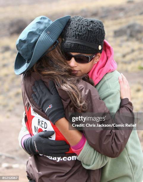 Cheryl Cole and Alesha Dixon embrace as they arrive in camp on the third day of The BT Red Nose Climb of Kilimanjaro on March 4, 2009 in Arusha,...