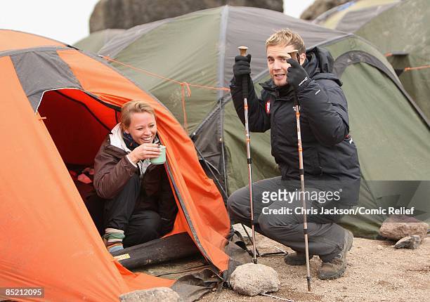 Gary Barlow and Kimberley Walsh have a cup of tea as they arrive in camp on the third day of The BT Red Nose Climb of Kilimanjaro on March 4, 2009 in...