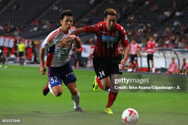 Atsushi Kawata of Albirex Niigata and Akito Fukumori of Consadole Sapporo compete for the ball during the J.League J1 match between Consadole Sapporo...