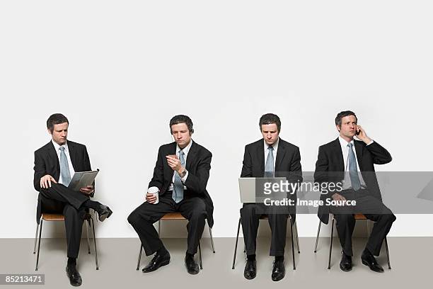 businessmen with different objects - multiple images of the same person stock pictures, royalty-free photos & images