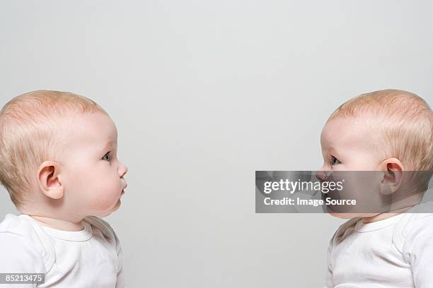babies face to face - identical twin stock pictures, royalty-free photos & images
