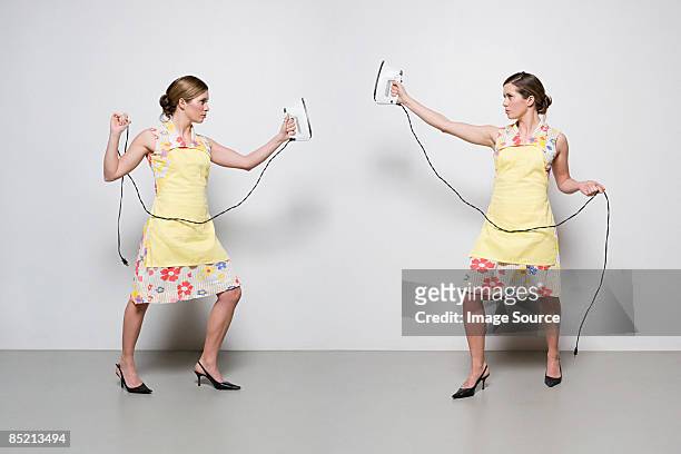 women with irons - multiple images of the same woman stock pictures, royalty-free photos & images
