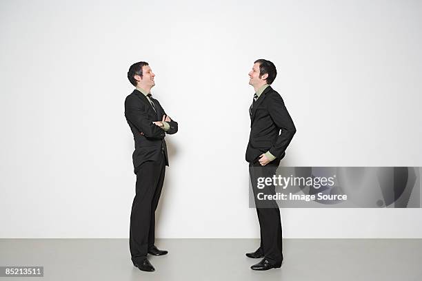 men having conversation - side profile face to face stock-fotos und bilder