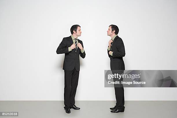 businessmen adjusting clothes - ties foto e immagini stock