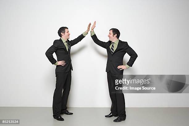 men doing high five - multiple images of the same person stock pictures, royalty-free photos & images