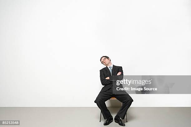 businessman sleeping in chair - man office chair stock pictures, royalty-free photos & images